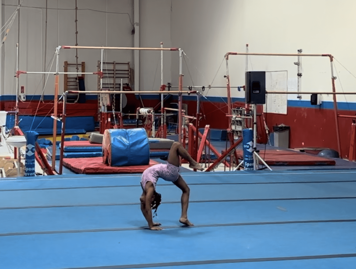 Open Gym advertisement for ages 6–12 showing a gymnast performing a floor skill in a large gym facility, with details about supervised exploration and class length.