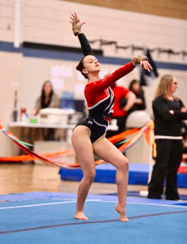 Alumni spotlight profile for Sabrina Pereira. To the left, a photo shows her as a young gymnast in a red and black leotard performing a floor routine pose. To the right, a current portrait shows her smiling in a grey athletic shirt inside a fitness facility with weight racks. The text details how her gymnastics background and experience with recovery inspired her career in exercise therapy.